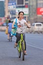 Young woman rides a public share bike, Beijing, China Royalty Free Stock Photo